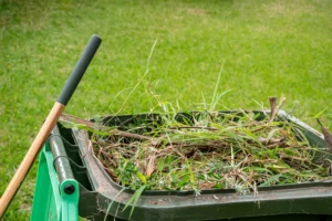 Landscaping waste bin filled with soil, branches, and yard debris in Edmonton